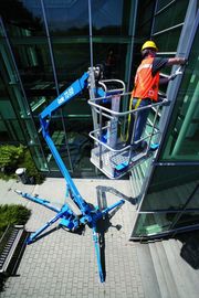 Подъемник Genie TZ-50, закрепление панелей на фасаде здания