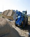 Погрузчик телескопический Genie GTH 4013 EX на строительной площадке
